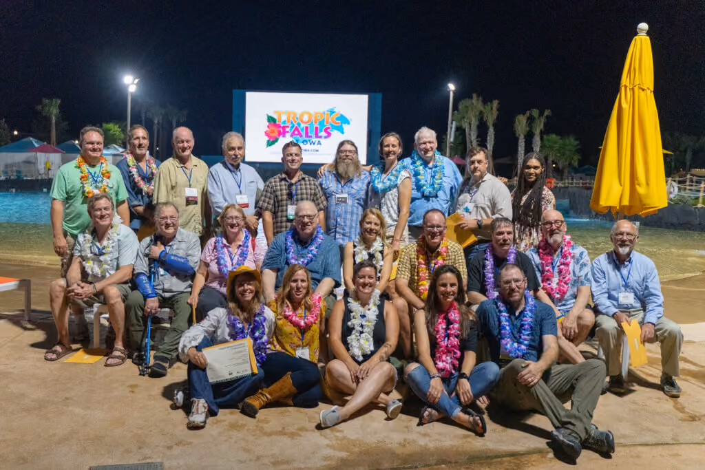 OWAA conference attendees networking and socialising outdoors for a group photo - Sched vs. Hubilo