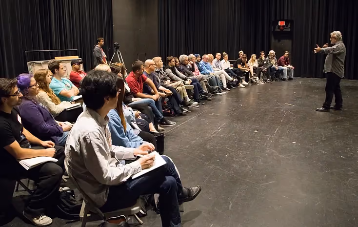 Improvisation college events - audience in chairs listening to expert improver