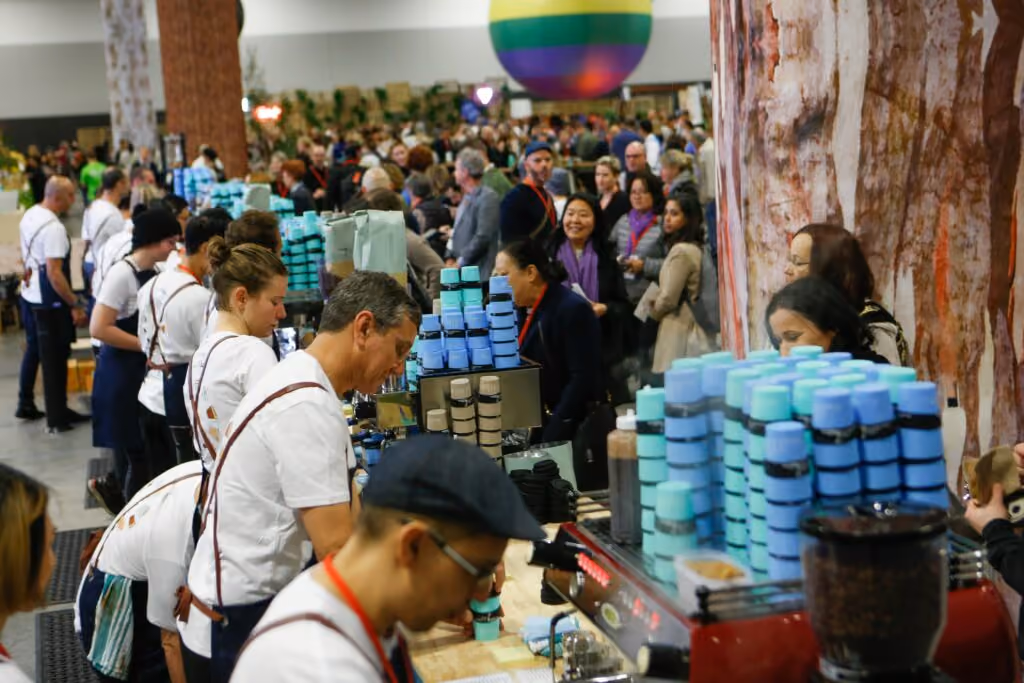 Globelet Reusable sustainability college events - row of baristas making coffee for event goers with reusable cups