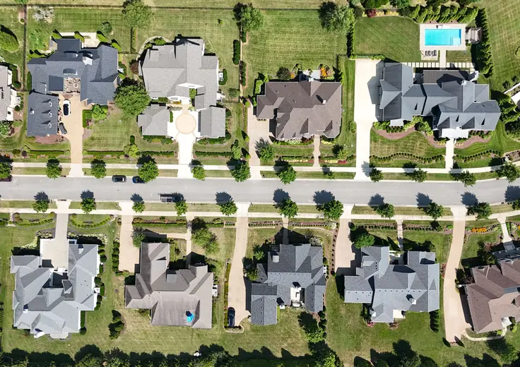 Aerial view of a residential street showing multiple separate single-family properties.