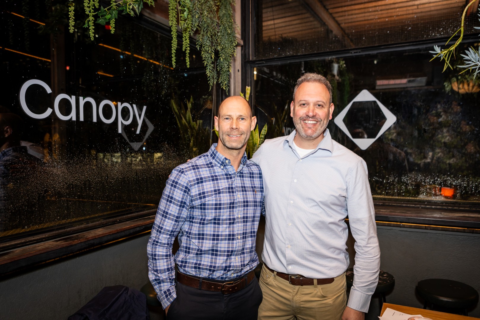 Guests in front of the Canopy logo window at the Canopy launch, Bomba Rooftop Bar, Melbourne