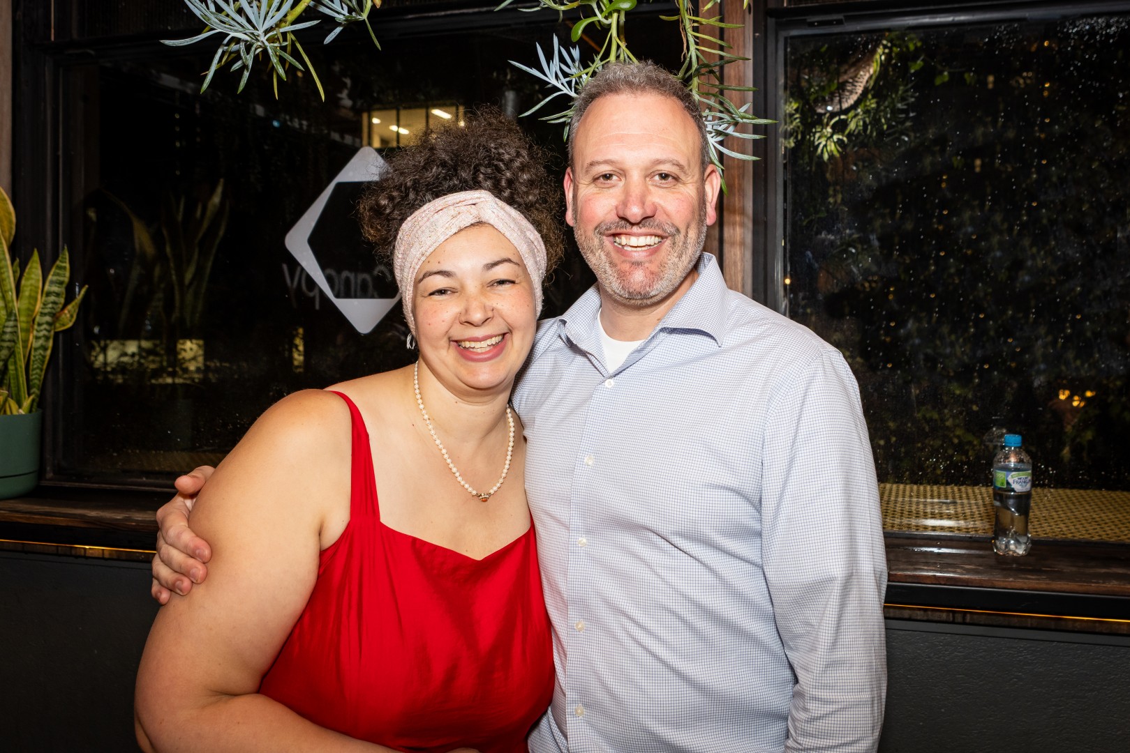 Guests in front of the Canopy logo window at the Canopy launch, Bomba Rooftop Bar, Melbourne