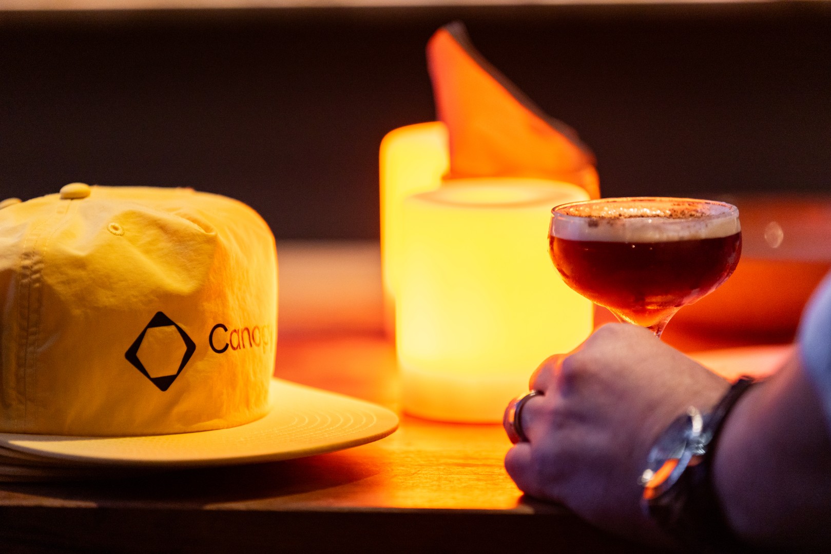Yellow Canopy cap beside an espresso martini at the Canopy launch