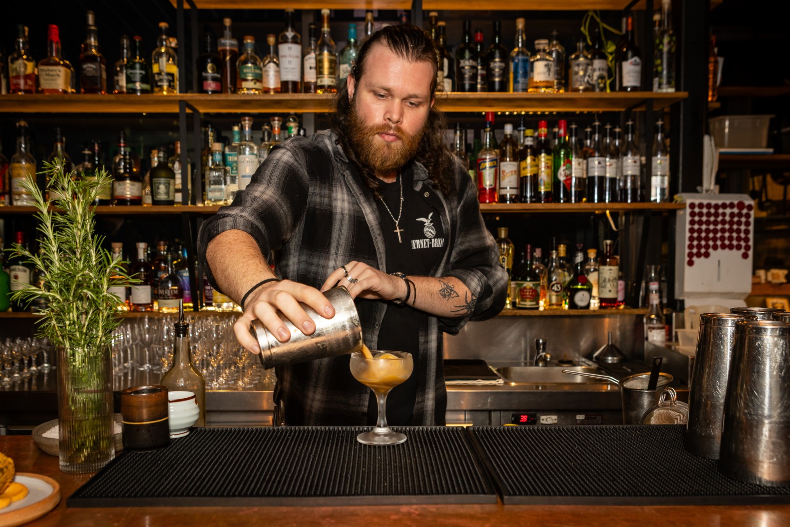 Bartender pouring a cocktail at the Canopy launch, Bomba Rooftop Bar