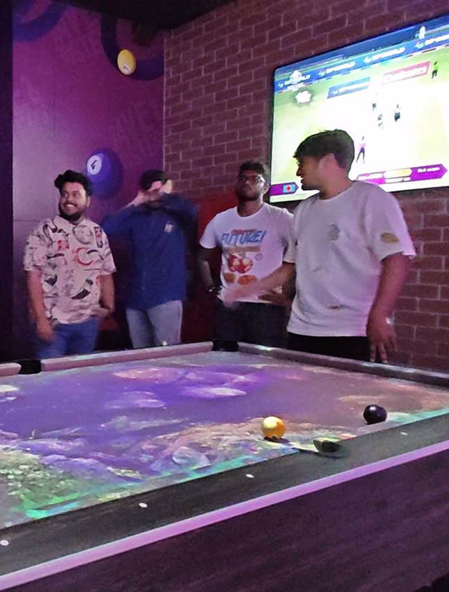Breathe ESG team playing pool at an offsite