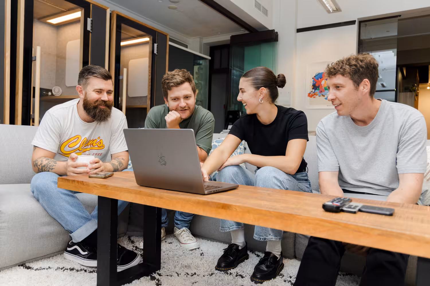 Askable team members working on a laptop in their Brisbane office