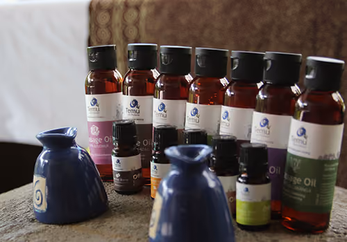 A row of massage oils and essential oils at Jamu Spa