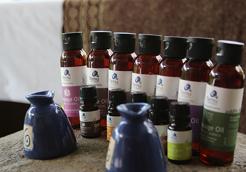 A row of massage oils and essential oils at Jamu Spa