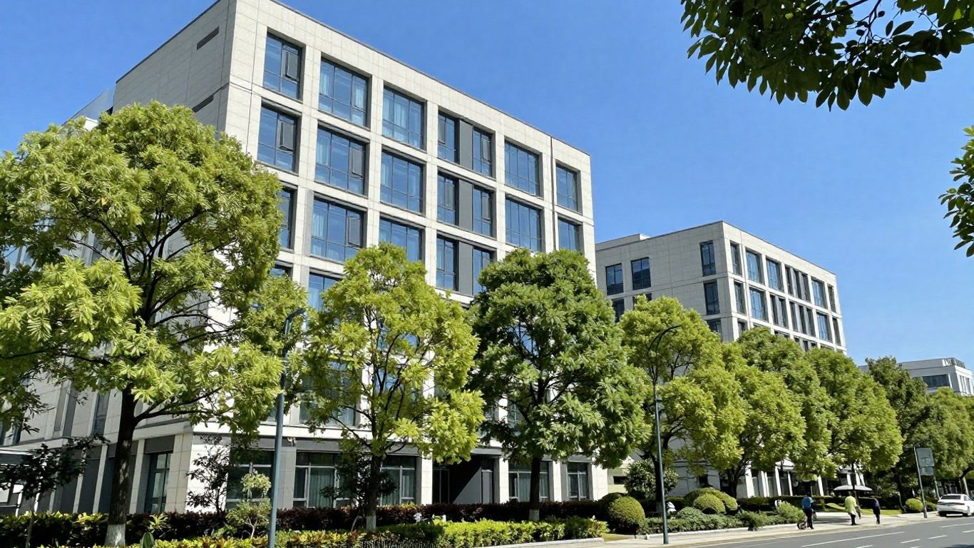 Corporate building with trees and blue sky.