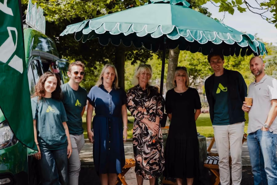 Guests under a parasol at an Adfin event