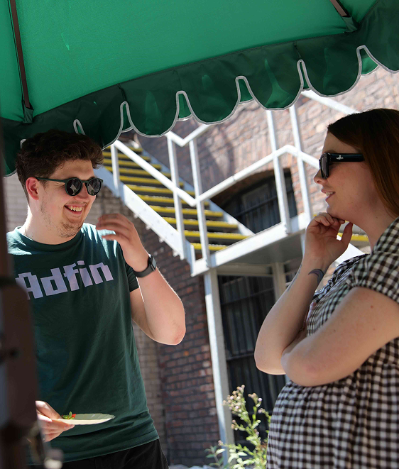 Guests under a parasol at an Adfin event