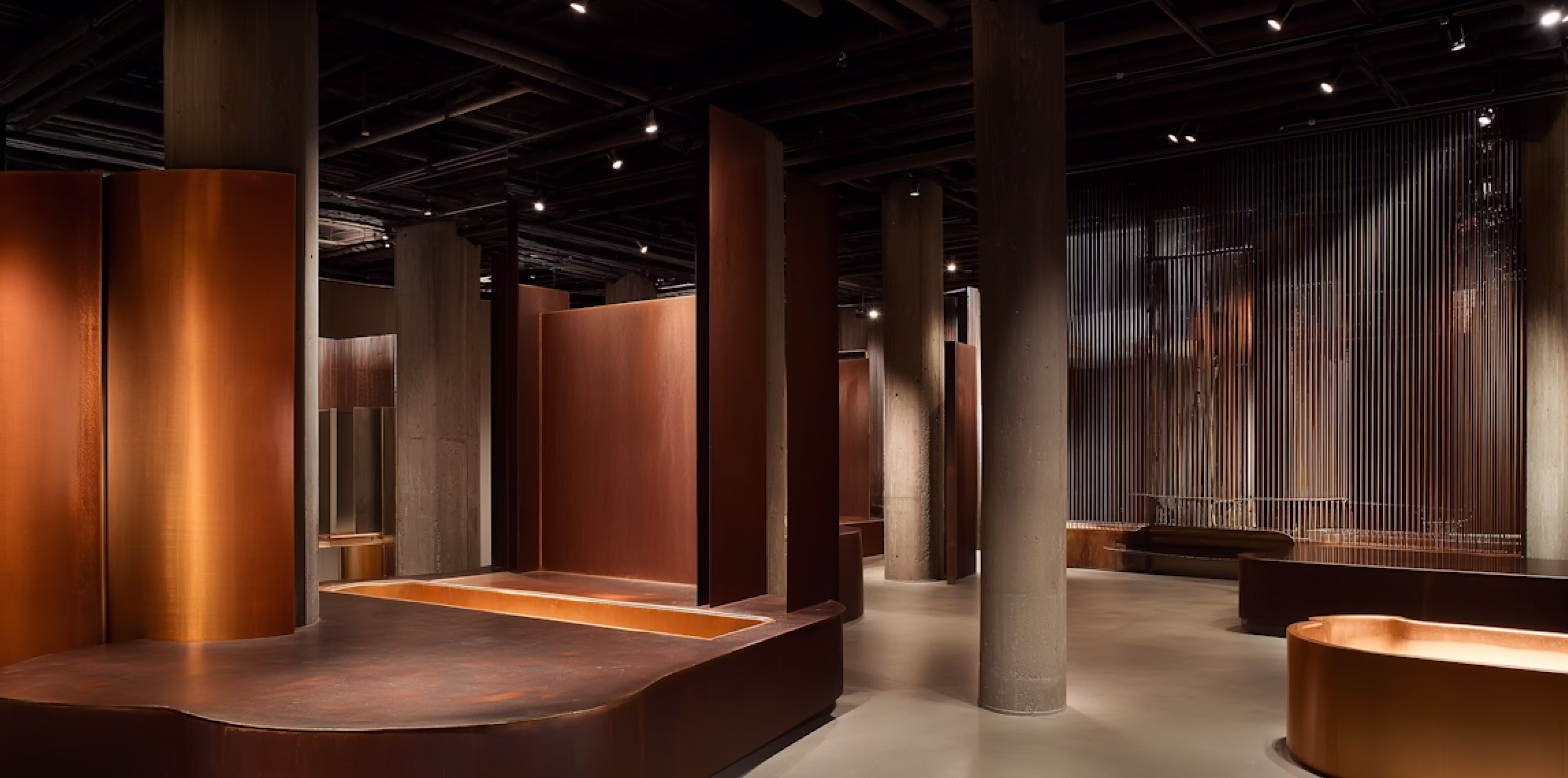 Modern industrial interior with warm pendant lighting and wood panel columns