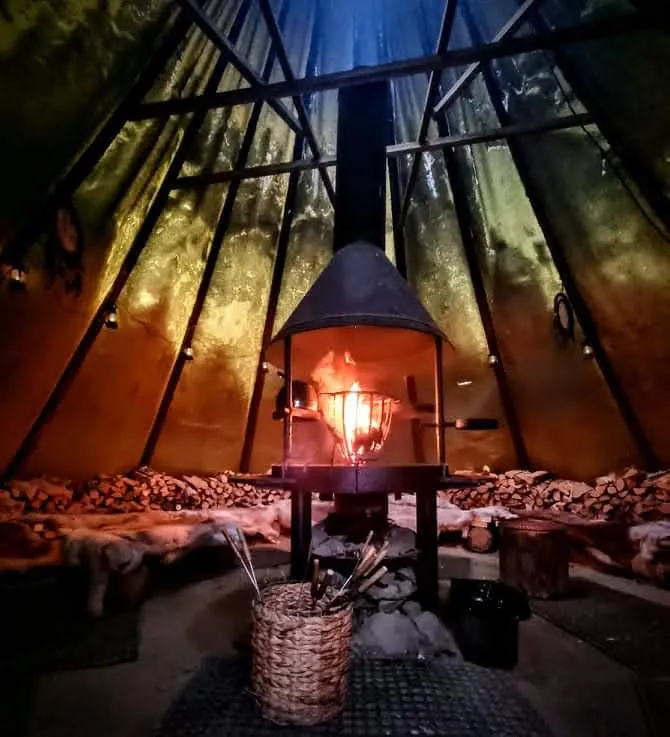 Warm campfire shelter at Tundra Huskies on a winter evening