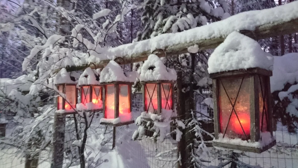 Glowing lanterns covered in snow at Tundra Huskies