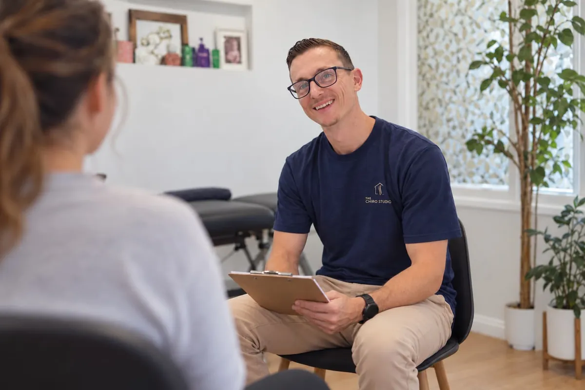 Andrew Ullo, chiropractor, talking with a patient at The Chiro Studio