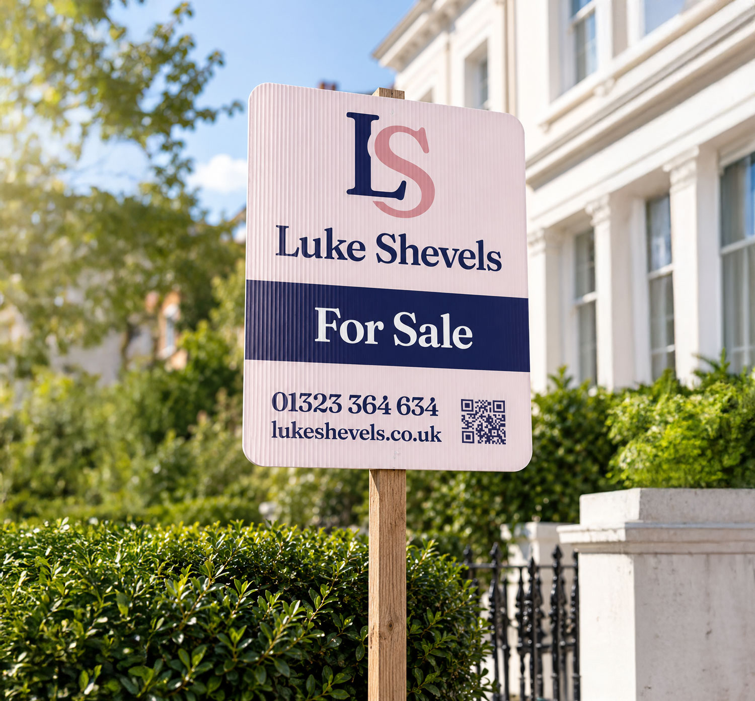 Luke Shevels real estate for sale sign displayed in front of white building.