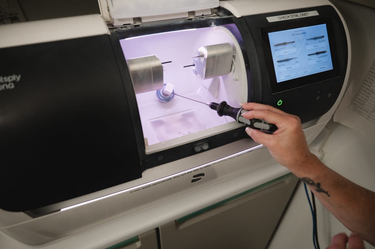 Dentist using digital CAD/CAM technology to design and mill a same-day crown