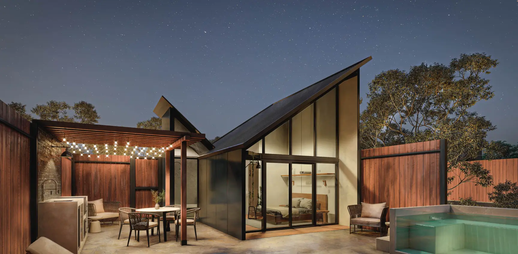 Modern angular villa lit at dusk with a swimming pool and terrace
