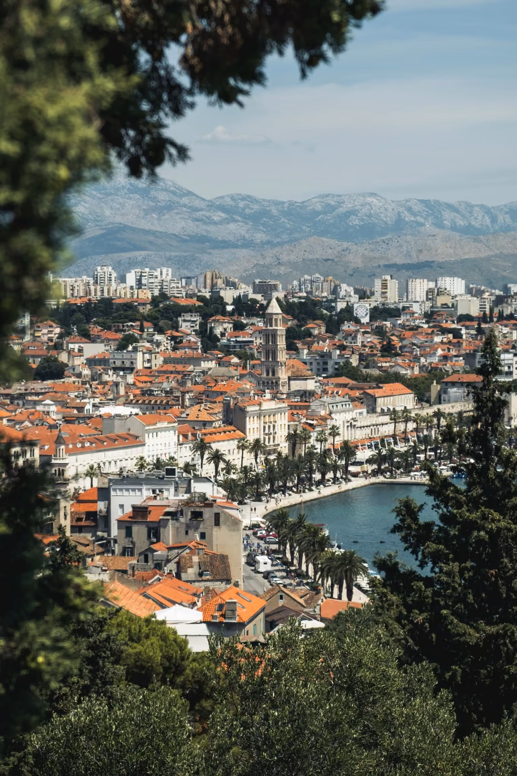 Coastal city and harbour on the Adriatic with mountains behind