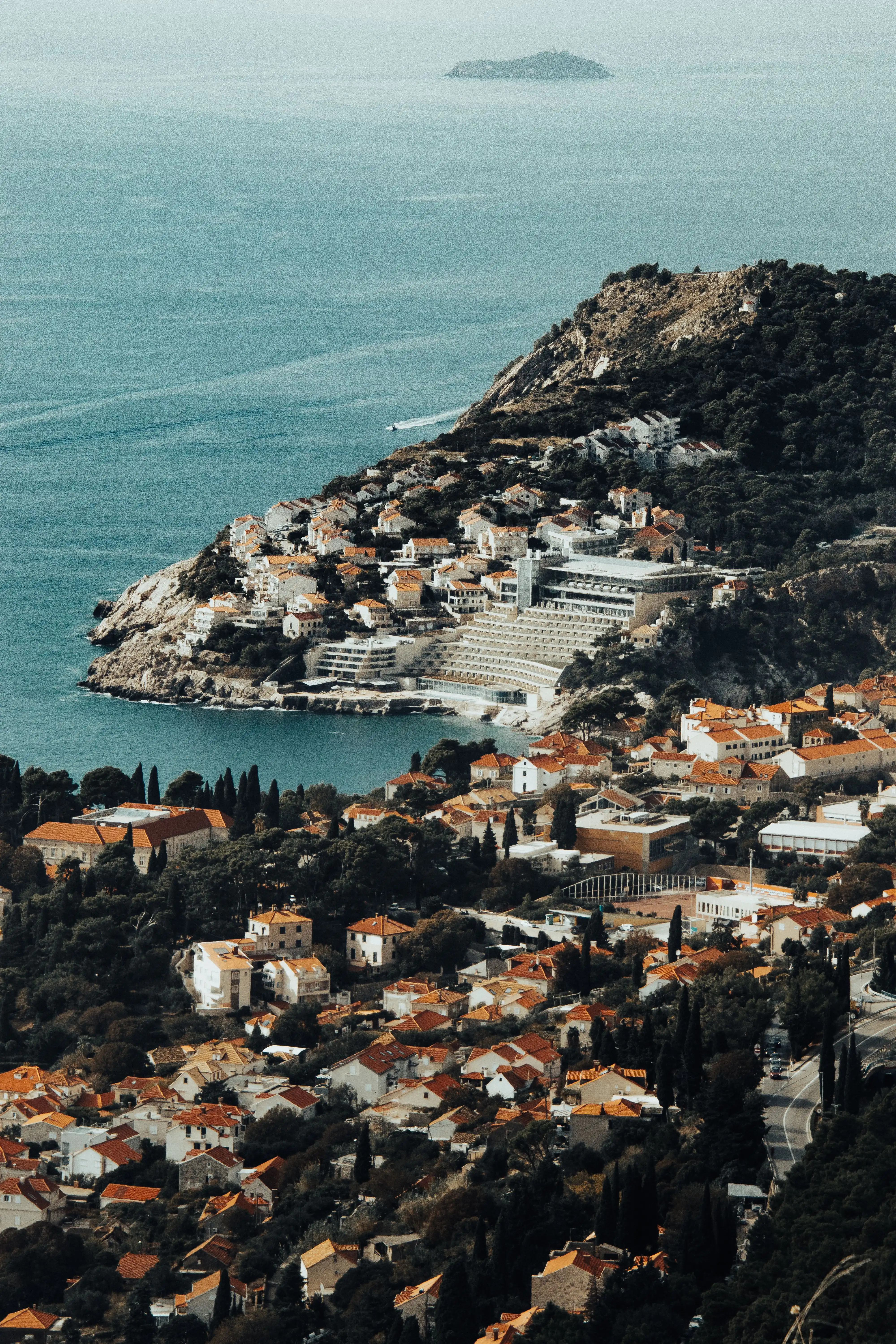 Aerial view of an Adriatic peninsula town surrounded by deep blue sea