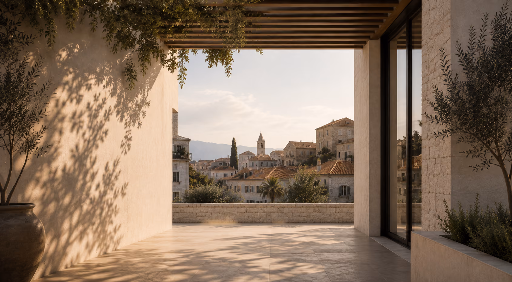 Shaded stone loggia opening onto a Mediterranean hillside village