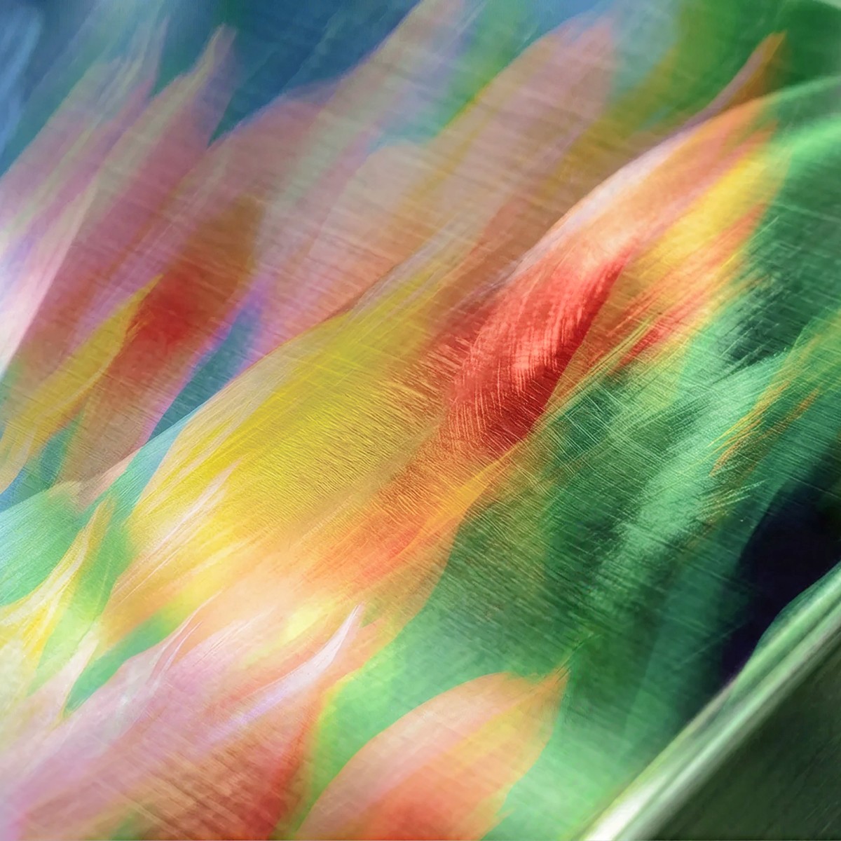 Abstract translucent layers of colour overlapping across a surface.