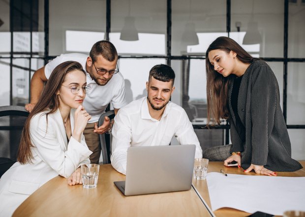 Team discussing a project at a laptop