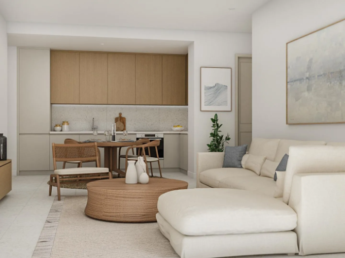 Open-plan living and dining area with a cream sofa and dining table