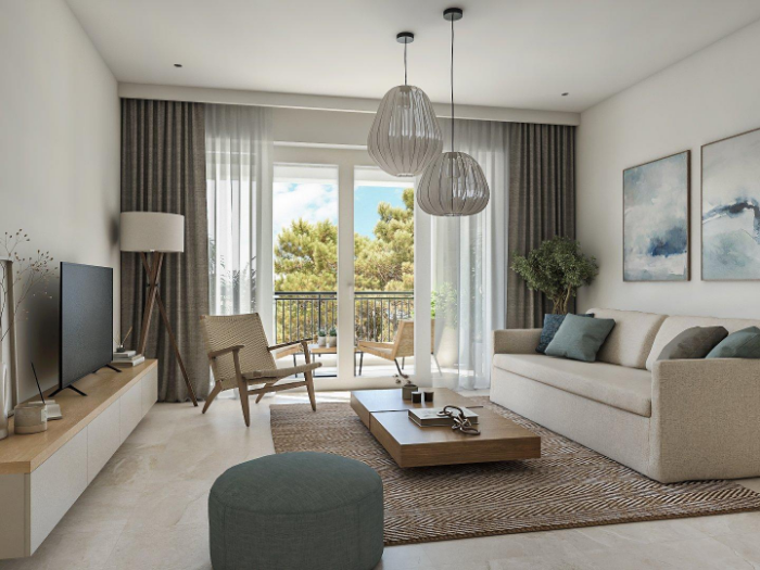 Living room with a sofa, TV unit, pendant lights and balcony doors to the sea