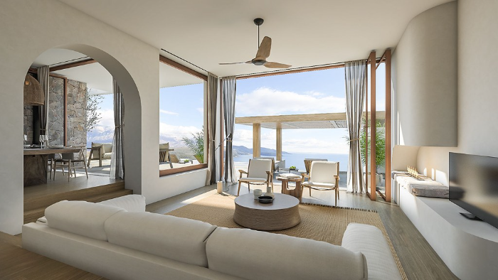 Town house living room with open sliding doors and a sea view