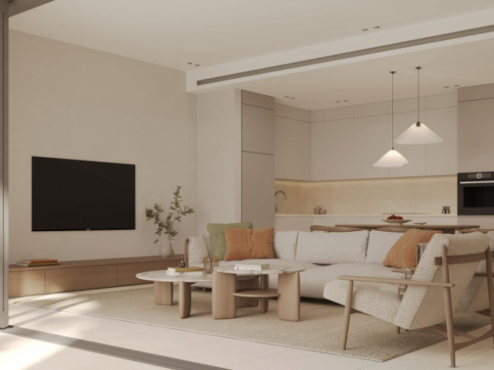 Open-plan living room with a wall-mounted TV, sofa and kitchen behind