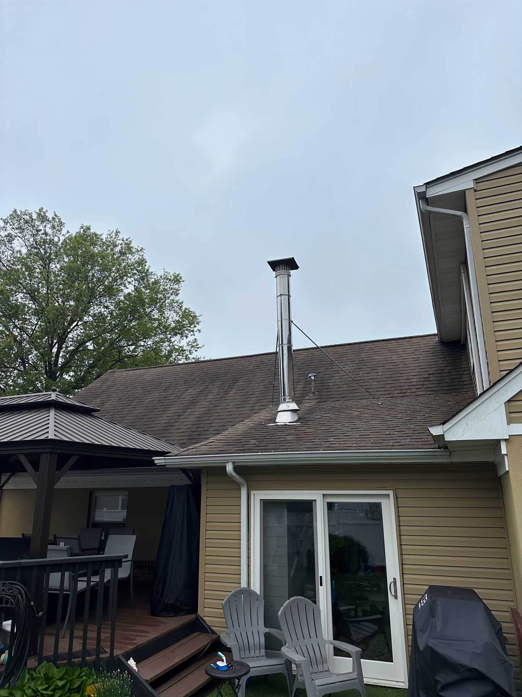 Home exterior with clean siding, windows and a wood deck after soft washing in northern New Jersey