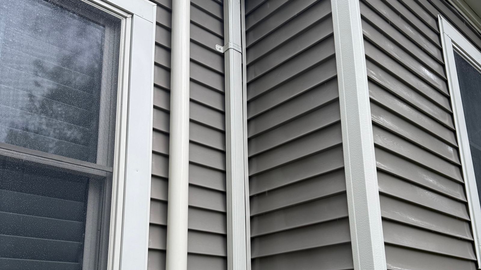 Clean siding and downspout on a North Jersey home after washing