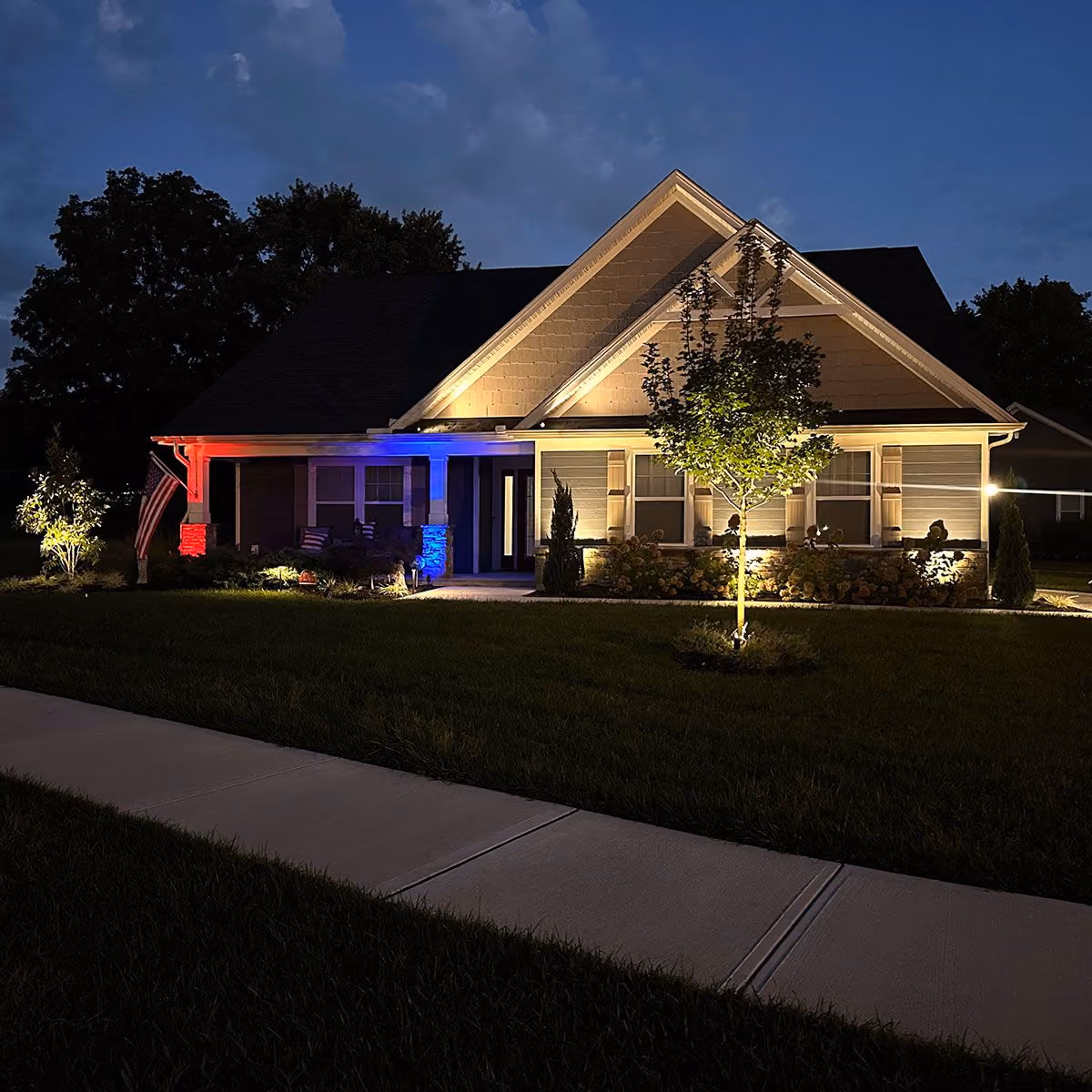 Triscapes professional landscape lighting near me illuminating walkways, trees, and outdoor features with warm low voltage lighting.