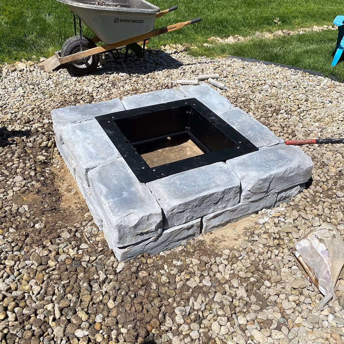 Triscapes custom hardscaping near me featuring a built-in fire pit and paver patio designed for outdoor entertaining.