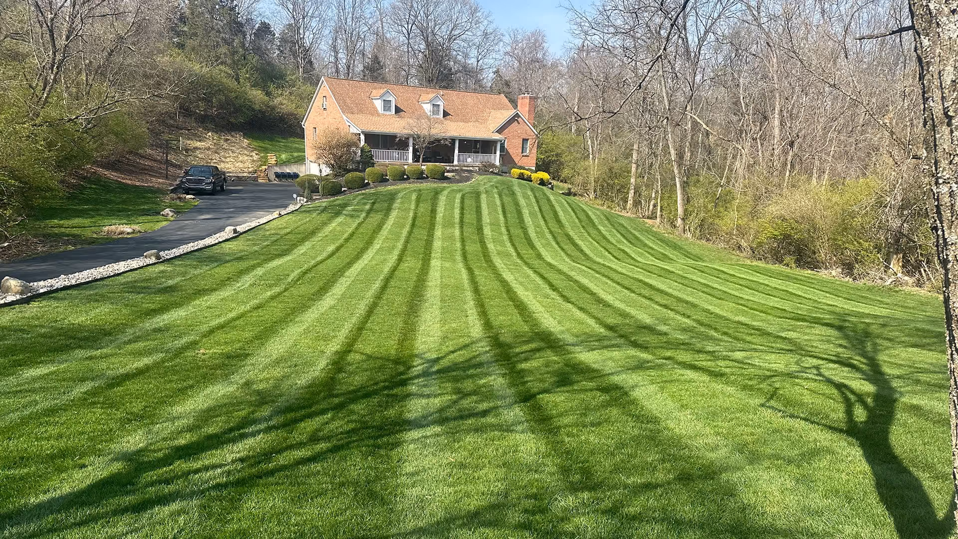 Triscapes professional lawn maintenance near me featuring freshly mowed grass, clean edging, and a well-maintained property.