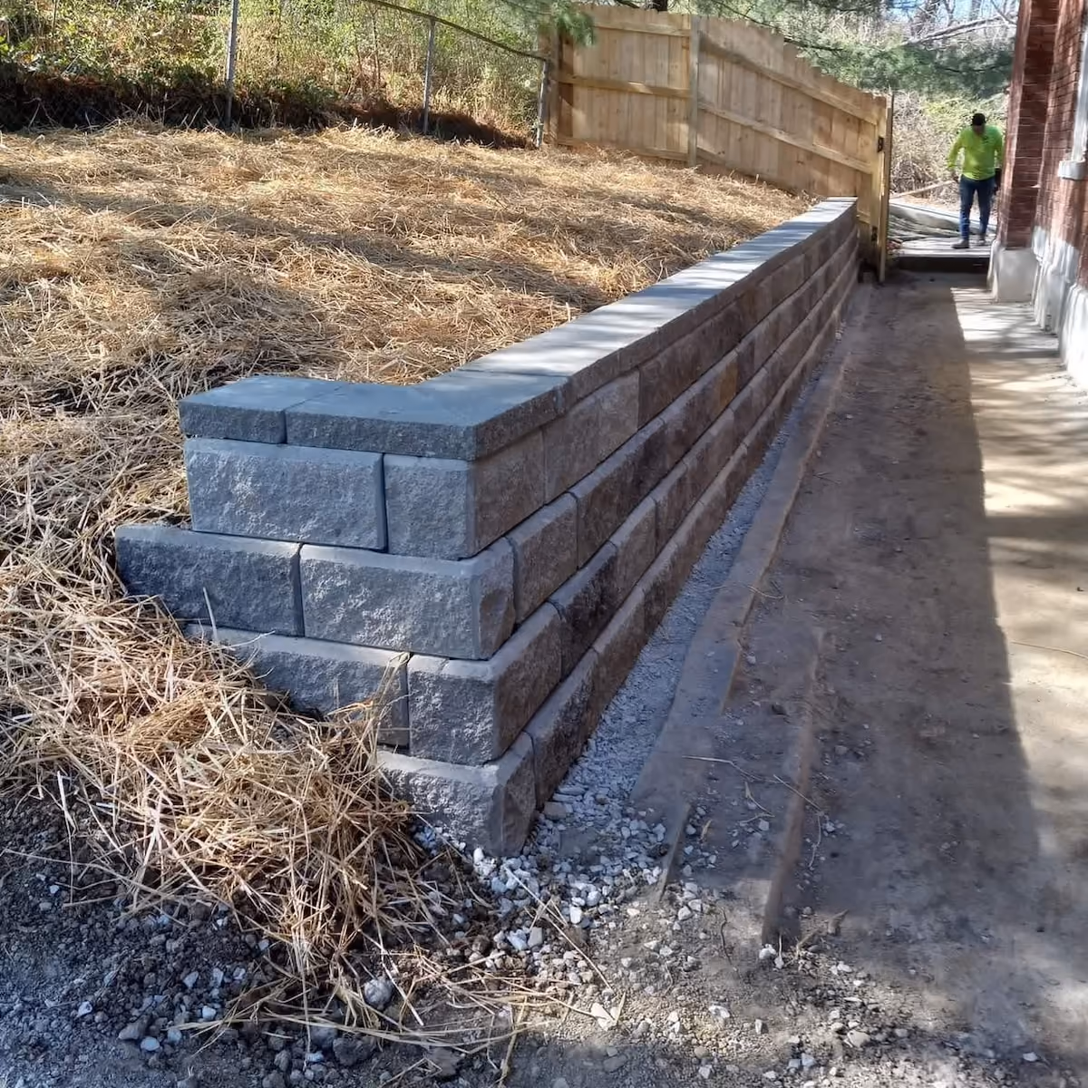 Custom hardscape installation with stone walkways, steps, and landscape edging by Triscapes