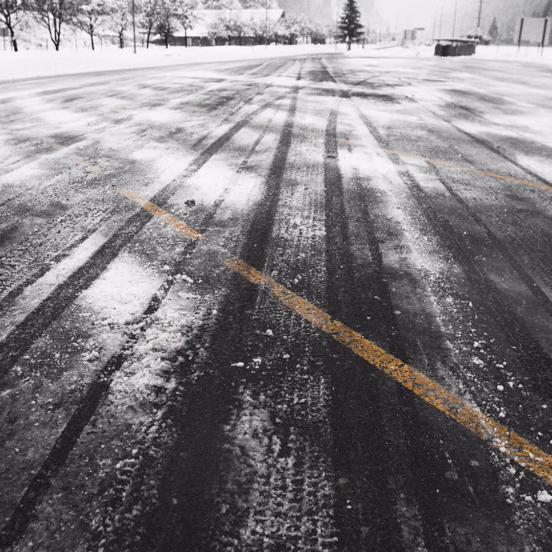Triscapes snow plowing truck clearing a commercial parking lot near me