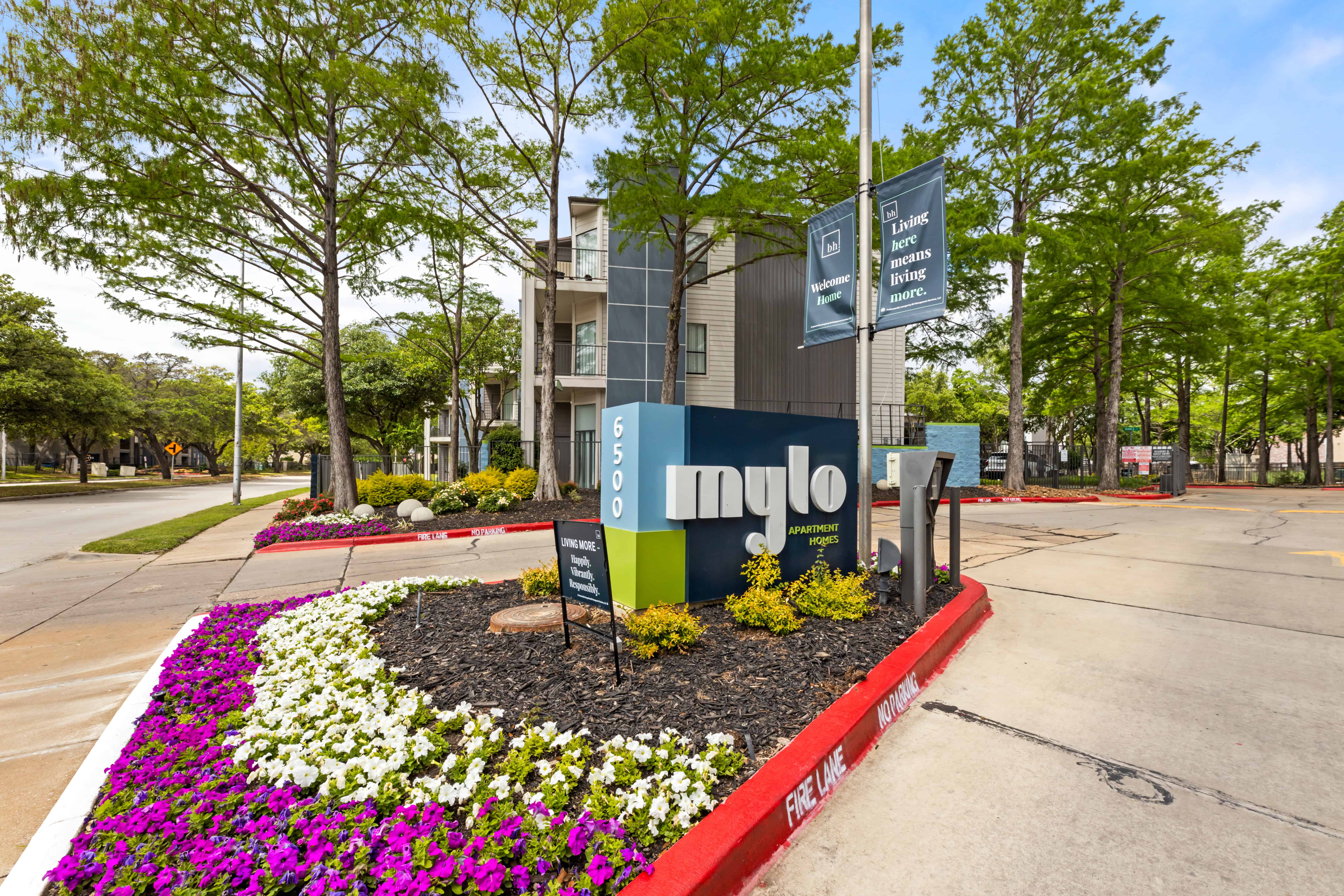 Exterior view showing apartment architecture and landscaping at Mylo