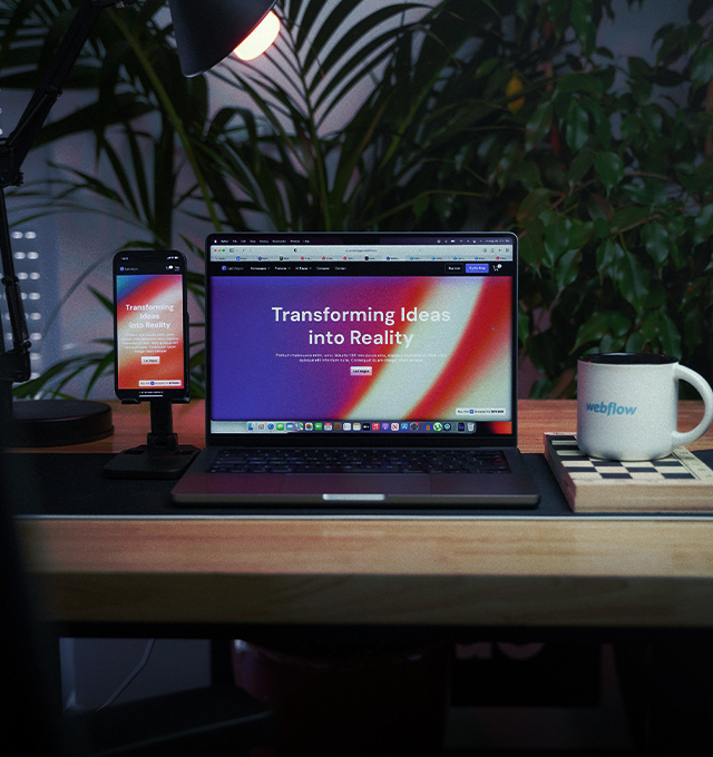 Modern workspace featuring a website displayed across desktop and mobile screens, highlighting digital experience and brand development services.
