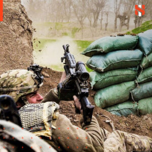 Kevin in army gear, holding a rifle