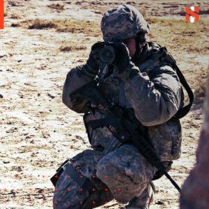 Kevin in Army gear, holding a camera