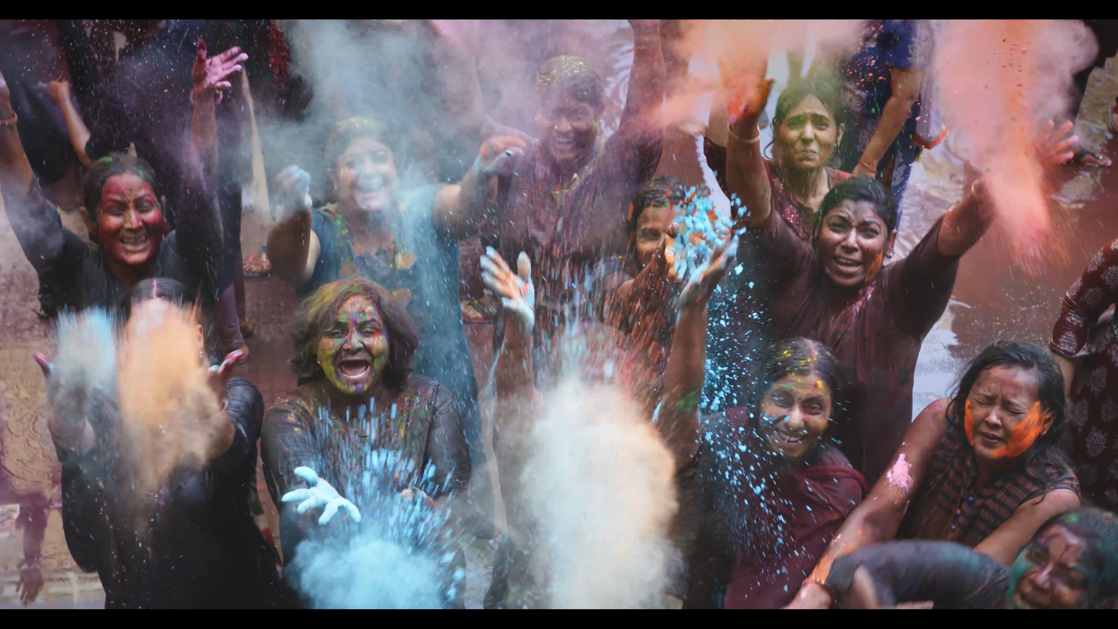 A crowd celebrating Holi, from LOVE | EVOL(ved)