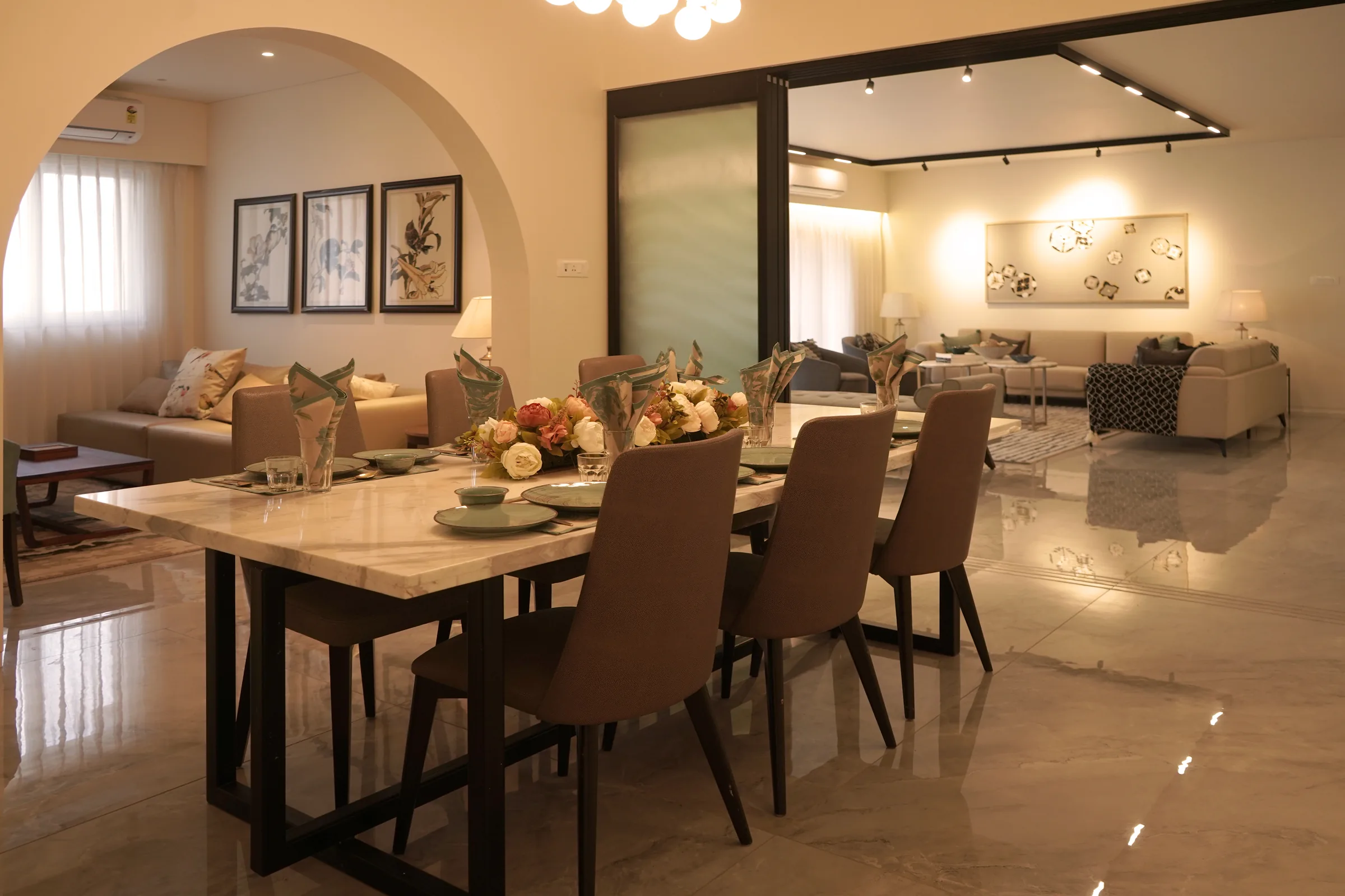 Kiara show apartment dining area through an arched doorway