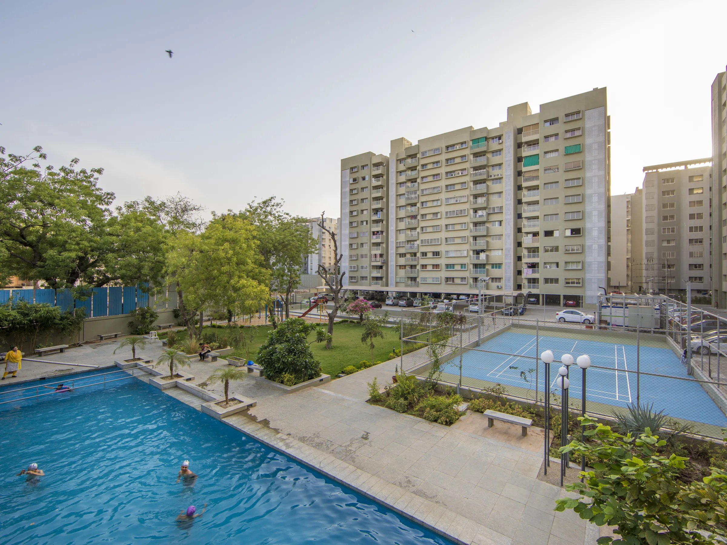 Veda towers around the swimming pool and sports court