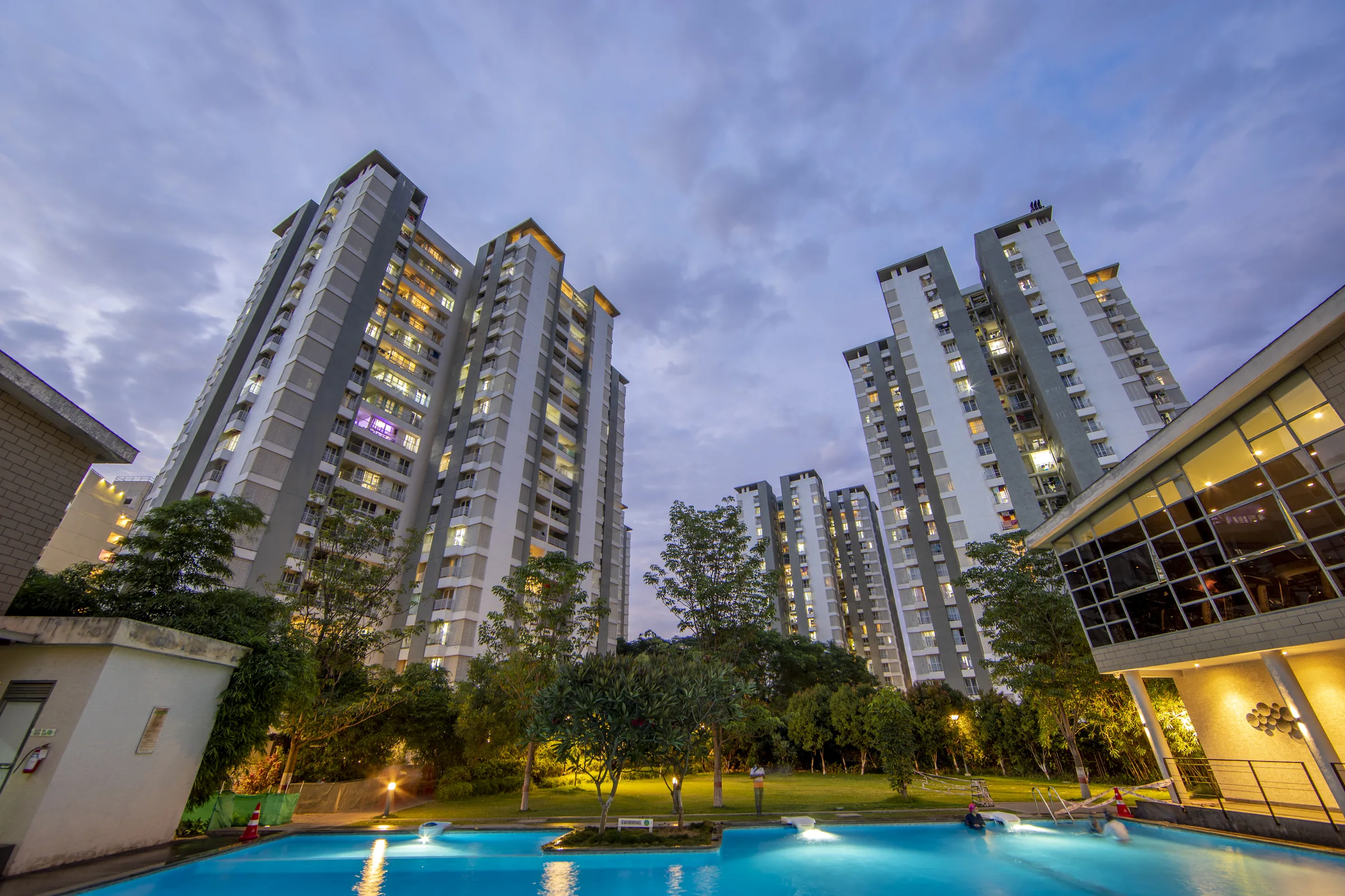 Urban Forest towers lit up above the pool at night