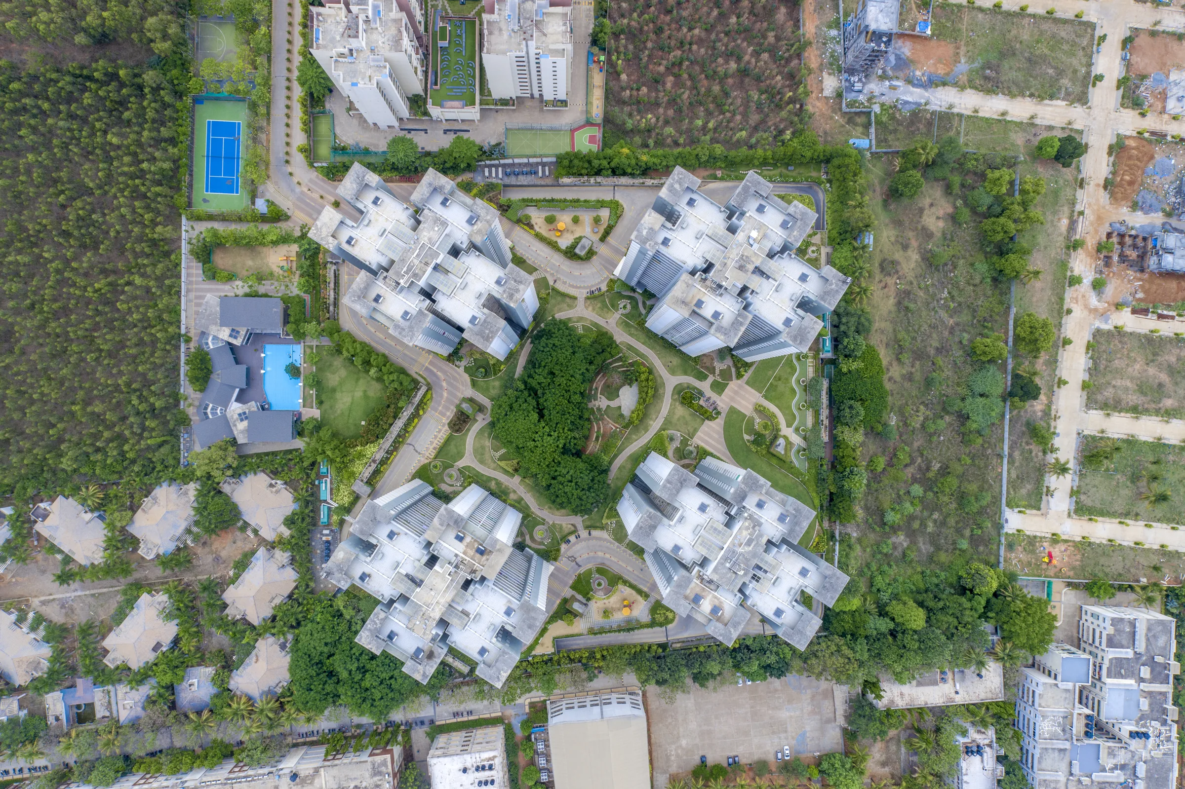 Top-down aerial of the four Urban Forest towers and green spaces