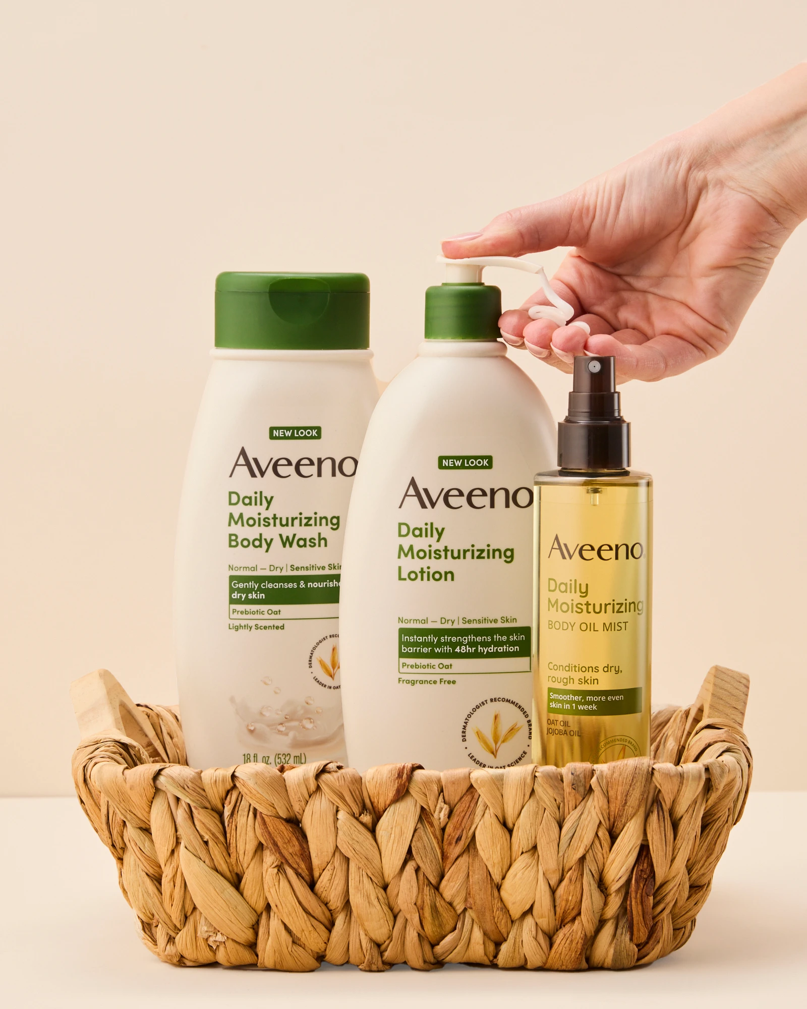 Aveeno bottles in a woven basket with a hand reaching toward them.