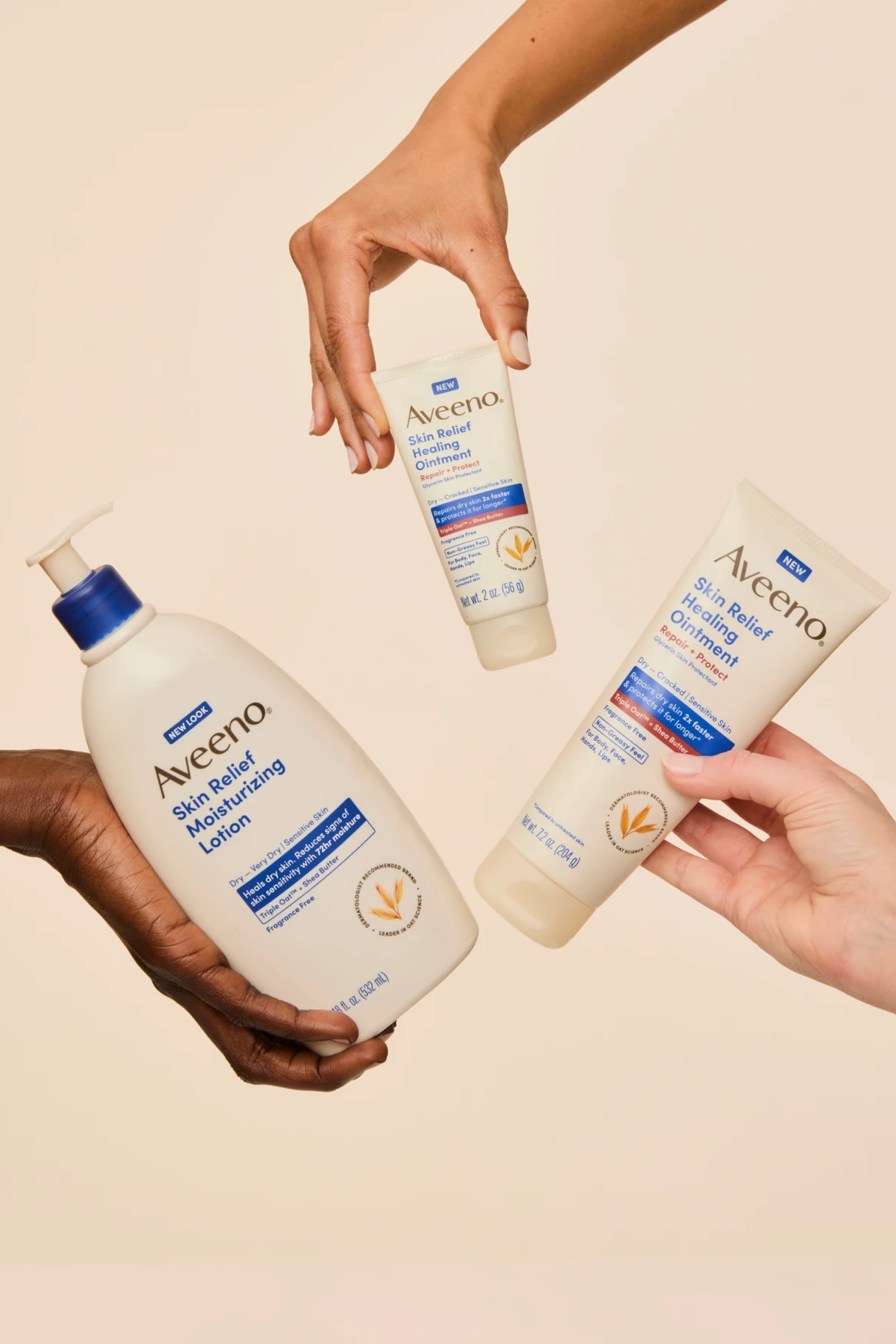 Hands holding three Aveeno products.