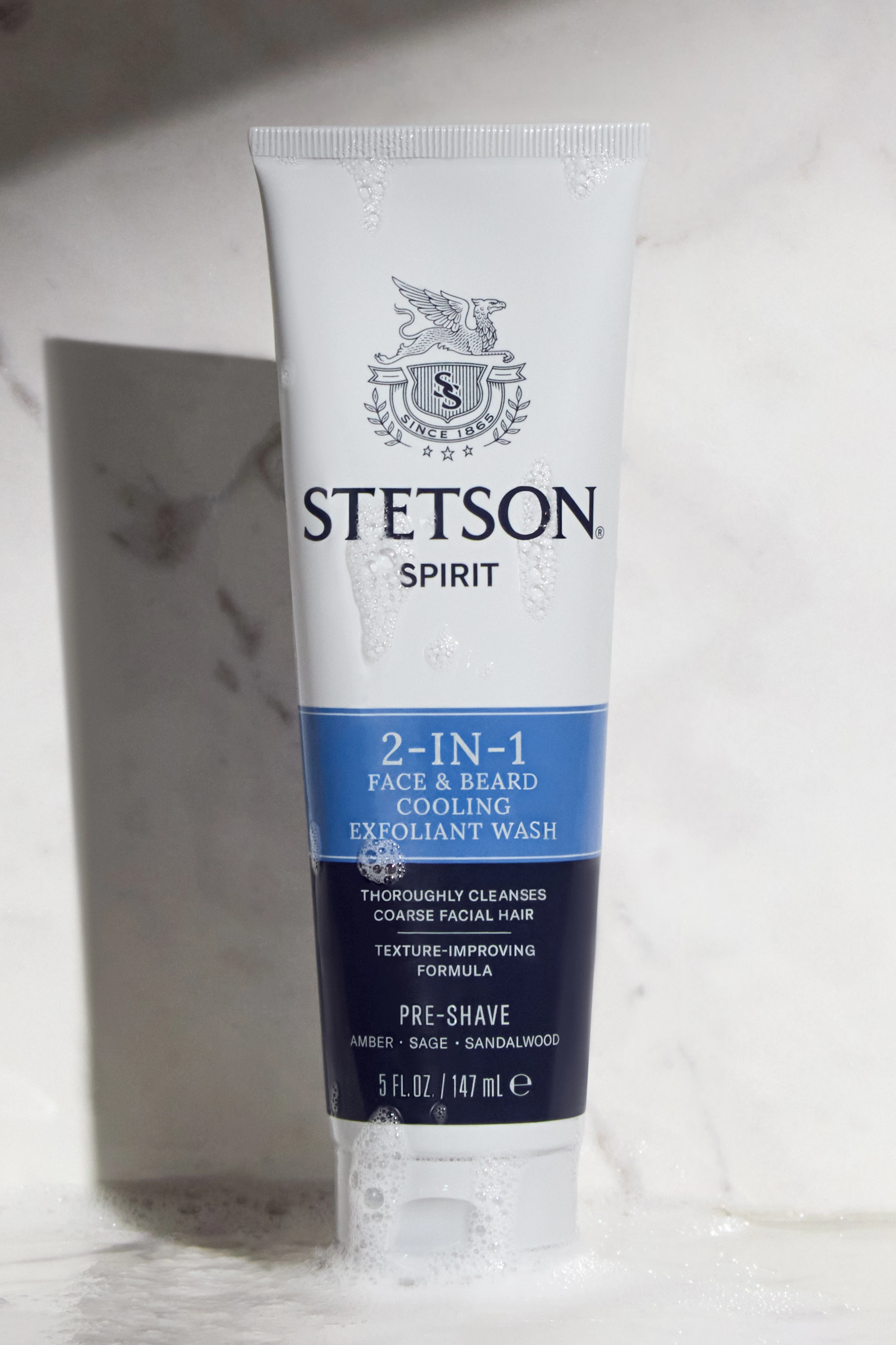A Stetson tube and its shadow against a pale wall.
